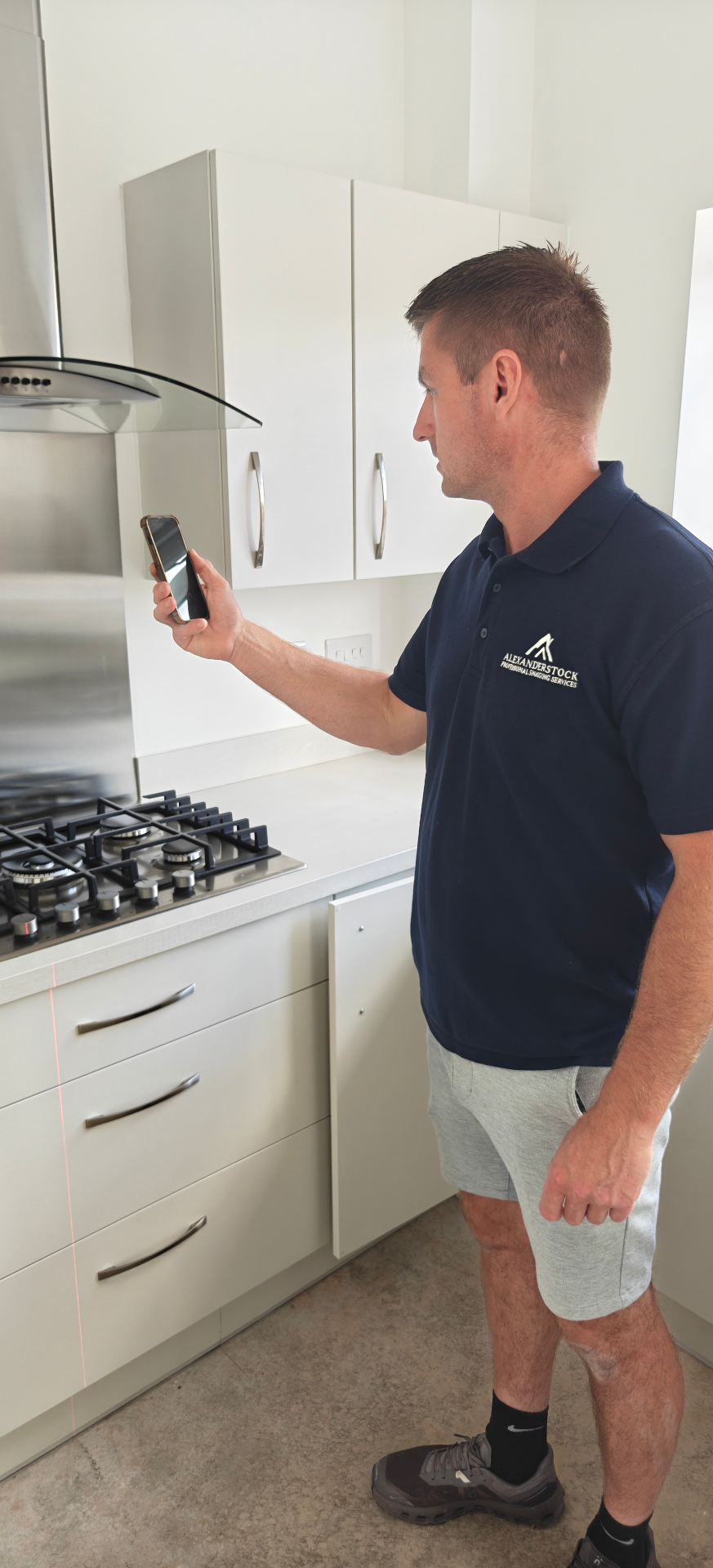 Inspector recording kitchen defects on a new build property inspection